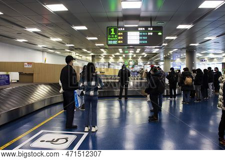 Korean People Foreign Travelers Journey And Waiting Receive Bag Luggage On Carousel Conveyor In Term