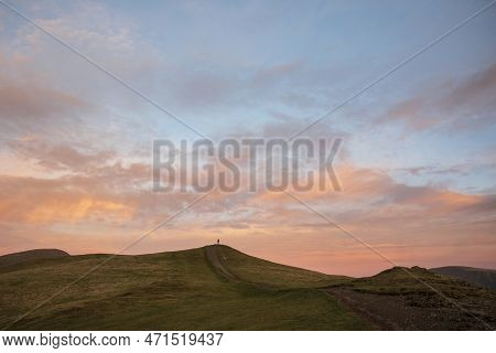 Beautiful Winter Sunset Landscape Over Latrigg Fell In Lake District With Single Perosn On Hilltop A