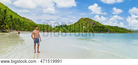 Young Man In Swim Short At A White Tropical Beach Anse Volbert Beach Praslin Seychelles