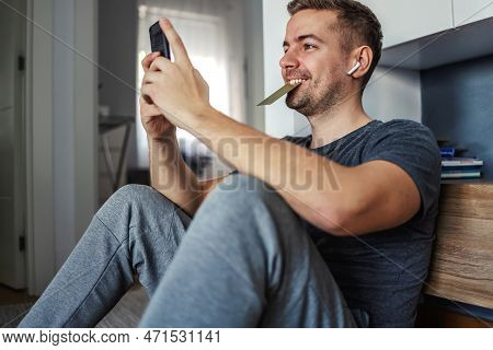 Online Hotel And Flight Reservations, Euphoria Over Travel. A Happy Young Male Person Sits Next To A