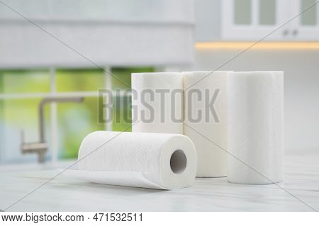 Many Rolls Of Paper Towels On White Marble Table In Kitchen