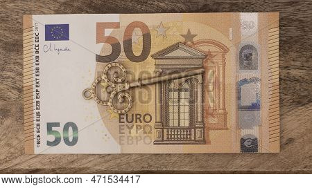 Fifty Euro Banknote With Old Vintage Key. Money Opens Many Doors. Ancient Key On Banknotes