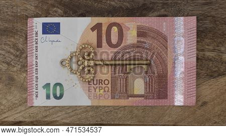 Ten Euro Banknote With Old Vintage Key. Money Opens Many Doors. Ancient Key On Banknotes