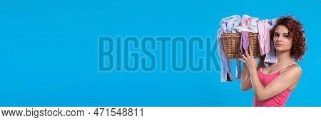 Narrow Frame Of The Photo. A Subdued Look On Her Face. A Girl Holds A Wicker Basket On Her Shoulder.