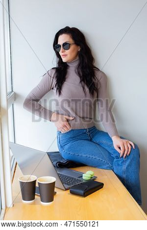 Beautiful Businesswoman Working On A Laptop. Female Freelancer Connecting To Internet Via Computer. 