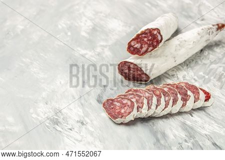 Sausage Fuet Dried Salami Meat On A Light Background. Banner, Menu, Recipe Place For Text, Top View.