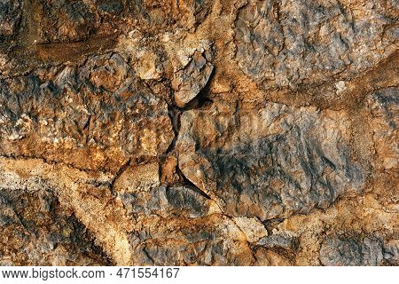 Old Worn Stone Wall Surface As Background. Detail From The Town Of Lovran In Croatia.