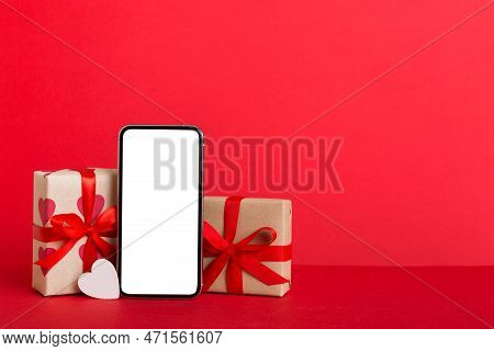 Mobile Phone With Blank Screen On Colored Background With Hearts, Calendar And Gift Box, Valentine D