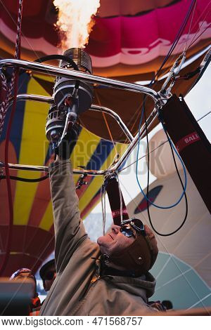A Pilot Firing Up The Burner And Being Illuminated By The Flames. Taken At 42nd International Balloo