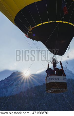 A Balloon Flying Along A Mountain Range Of The Swiss Alps With A Sunburst Effect. Taken At 42nd Inte