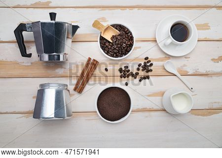 Cup Of Coffee, Geyser Coffee Maker, Milk And Beans Coffee On ,white Wooden Table. Top View.
