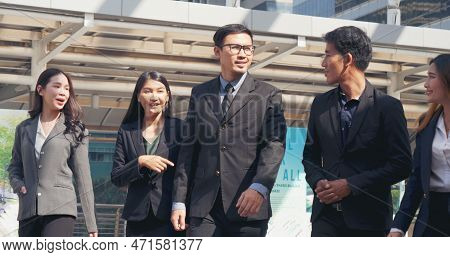 Group Of Business People Asian Team Partners Walking In City Happy Together. Leader Executive Men St