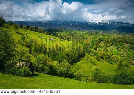 Majestic Summer Countryside Landscape With Fresh Green Forests On The Hills And Snowy Piatra Craiulu