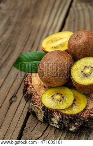Closeup Ripe Golden Kiwi Fruit. Food Background. Vertical Image. Top View. Place For Text.