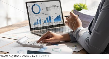 Business Woman Using Calculator To Calculate Financial Report, Working At Office With Laptop Compute