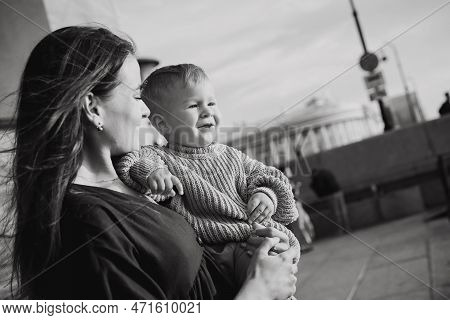 Beautiful Caucasian Young Mom Holding Baby Son At The Quay Of City Saint-petersburg, Russia. High Qu
