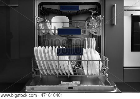 Built-in Dishwasher In The Kitchen With The Door Open And Clean Dishes Inside. Clean White Plates, S