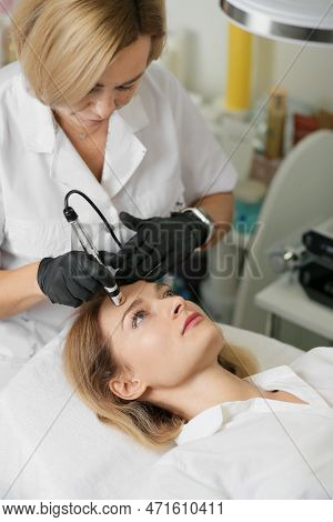 Rejuvenating Facial Therapy Treatment At Spa Salon Clinic. Young Beautiful Woman Getting Lifting Ant