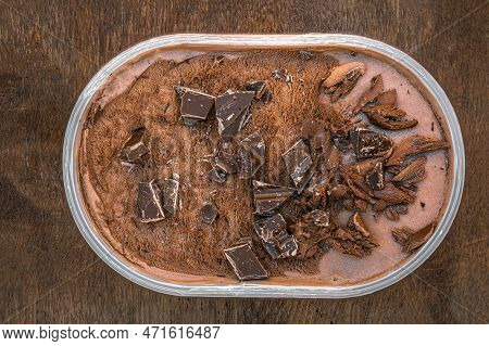 Chocolate Icecream On A Wooden Rustic Background. Dark Chocolate  Ice Cream In A Conteiner