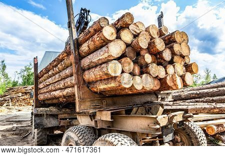 Timber Carrier With Sawn Logs At The Wood Storage Place. Forest Industry. Renewable Natural Resource