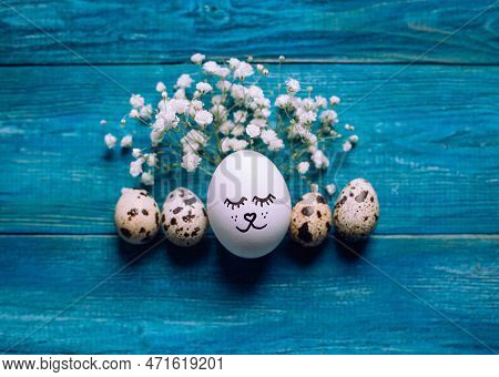 Simple Diy Easter Egg With Drawn Cute Face Surrounded With Quial Eggs And Gypsophila Branches On Rus