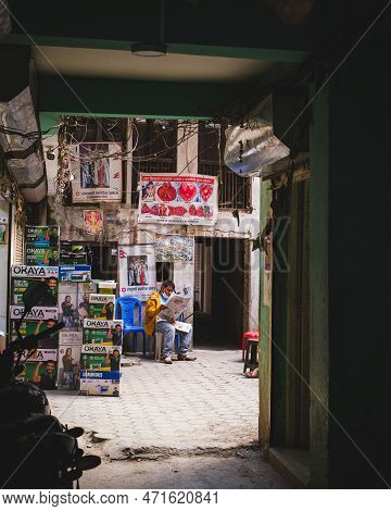 Kathmandu, Nepal, 04 23 2022: A Woman Sitting In A Back Alley