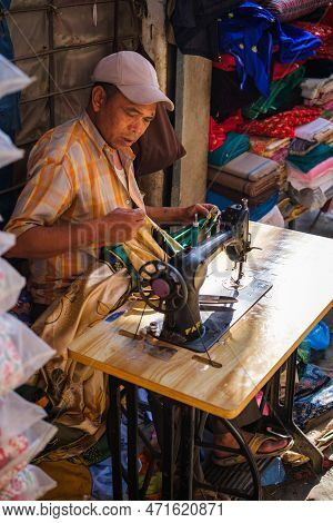Kathmandu, Nepal, 04 23 2022: A Woman With A Sewing Machine In The Bazaar Of Kathmandu