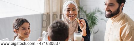 African American Woman In Hijab Holding Cevizli Sucuk During Suhur With Family At Home, Banner.
