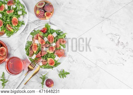 Autumn Figs Salad With Arugula, Feta, Raw Ham In Two White Plate On Light Marlbe Background Served W