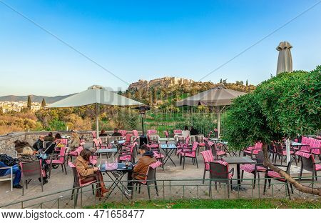 Athens, Greece - January 7 2023: Seated People  In A Sidewalk Cafe, In Thissio District, With The Ac