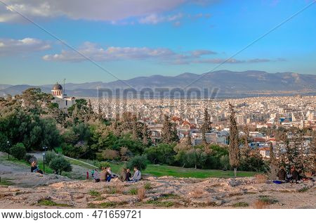 Athens, Greece - January 7  2023: Incidental People On The Hill Of Pnyx Enjoy The Skyline Of Athens 