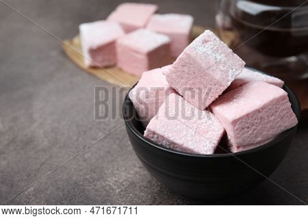Bowl Of Delicious Sweet Marshmallows With Powdered Sugar On Brown Table, Closeup. Space For Text