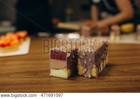 Beautiful Young Chef Decorating Delicious Dessert On Modern Kittchen