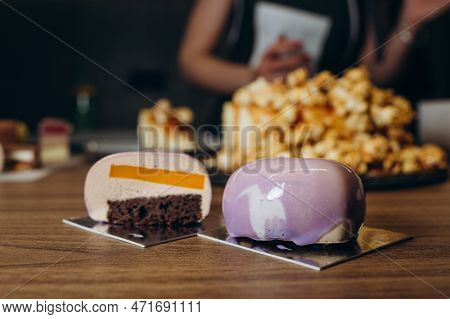 Beautiful Young Chef Decorating Delicious Dessert On Modern Kittchen