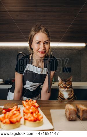 Funny Bengal Cat In The Kitchen Dressed As A Cook.