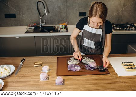 Beautiful Young Chef Decorating Delicious Dessert