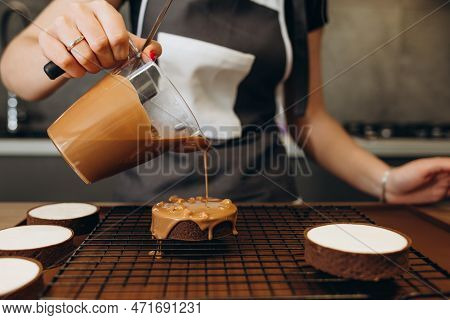 Beautiful Young Chef Decorating Delicious Dessert  In Modern Kittchen
