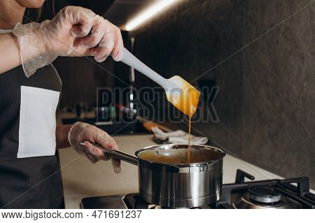 Beautiful Young Chef Decorating Delicious Dessert  In Modern Kittchen