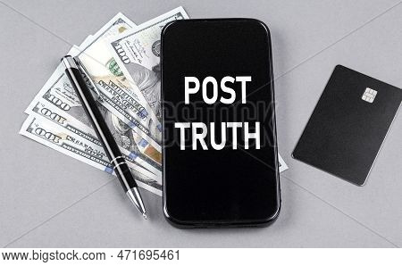 Credit Card And Text Post Truth On A Smartphone With Dollars And Pen. Business Concept