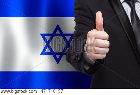 Izraeli Concept. Businessman Showing Thumb Up On The Background Of Flag Of Izrael