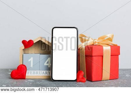 Mobile Phone With Blank Screen On Colored Background With Hearts, Calendar And Gift Box, Valentine D