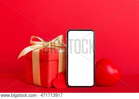 Mobile Phone With Blank Screen On Colored Background With Hearts, Calendar And Gift Box, Valentine D