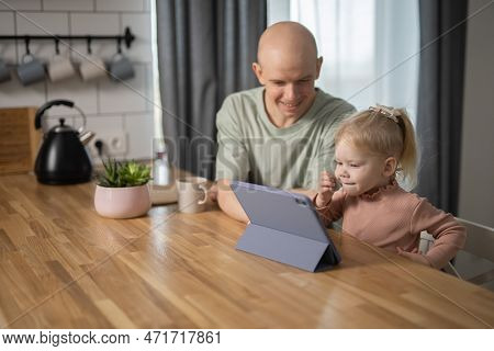 People With Cochlear Implant System. Kid Study To Hear With Her Father, Learning With Video On Table