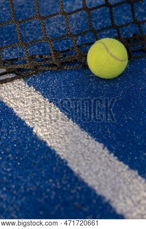 Paddle Tennis Ball In The Net Of A Blue Paddle Tennis Court. Racket Sport Courts