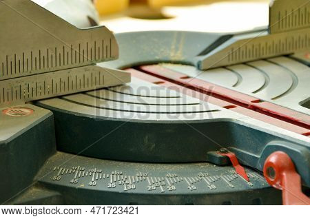 Ruler Of Electric Circular Saw, Cutting Piece Of Wood. Trimming Saw On Dusty Table