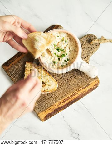 Sour Cream, Yogurt And Caramelized Onion Spread Dip In The Bowl On Wood Board. Bread Pieces Are Near