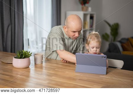 People With Cochlear Implant System. Kid Study To Hear With Her Father, Learning With Video On Table
