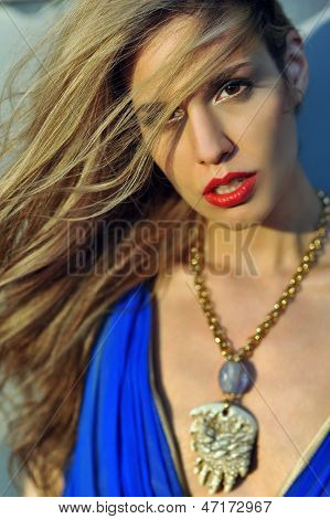 Closeup portrait of fashion model with full hair and red lips posing sexy