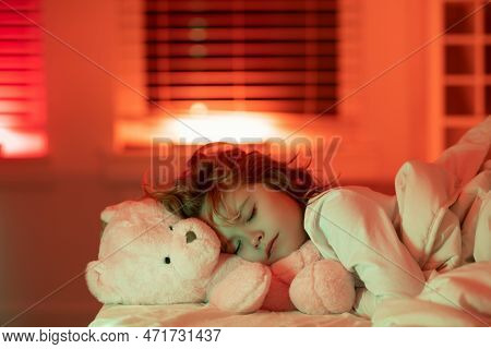 Kid Enjoying Sweet Dreams. Kid Sleeping In Bed With A Toy Teddy Bear. Child Sleeping Under Blanket, 
