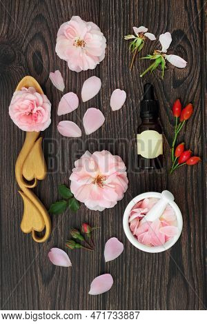 Rose Flower Essence With Flowers For Aromatherapy Essential Oil And Rosehips For Natural Herbal Plan